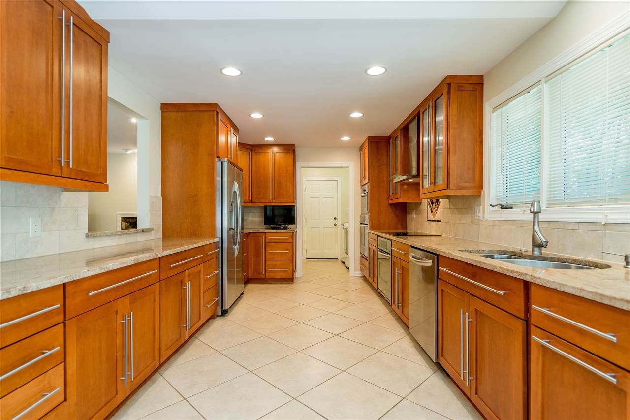 2108 Countrywood Road North Raleigh, NC 27615 - Photo 11 of 30 Maple cabinets, 18 inch tile flooring, granite counters, stainless steel appliances plus more! Spectacular Kitchen