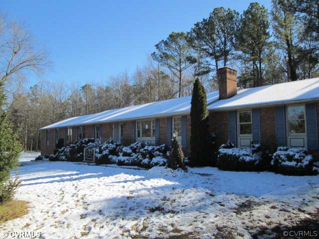 2961 Kinvan Road Richmond, VA 23231 - Photo 1 of 1 a front view of house with yard and trees in the background