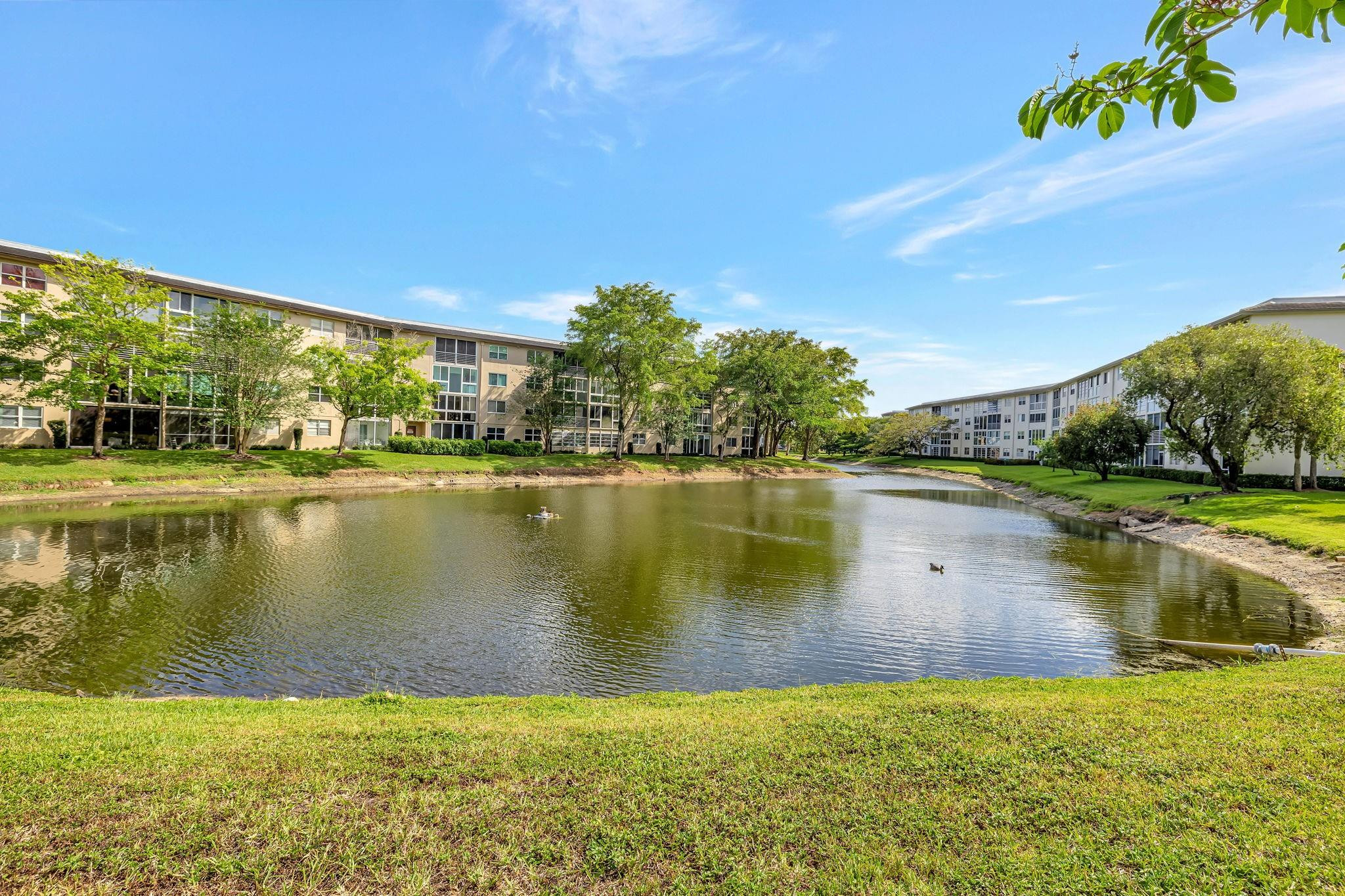1801 Eleuthera Point, Unit E1 Coconut Creek, FL 33066 - Photo 14 of 50 a view of a lake with houses in the background