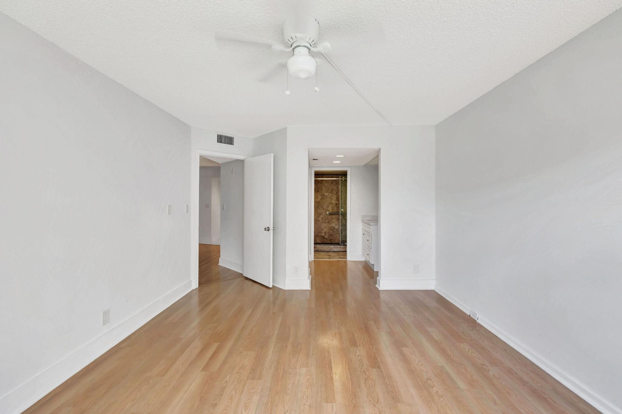 1801 Eleuthera Point, Unit E1 Coconut Creek, FL 33066 - Photo 20 of 50 wooden floor in an empty room with a window