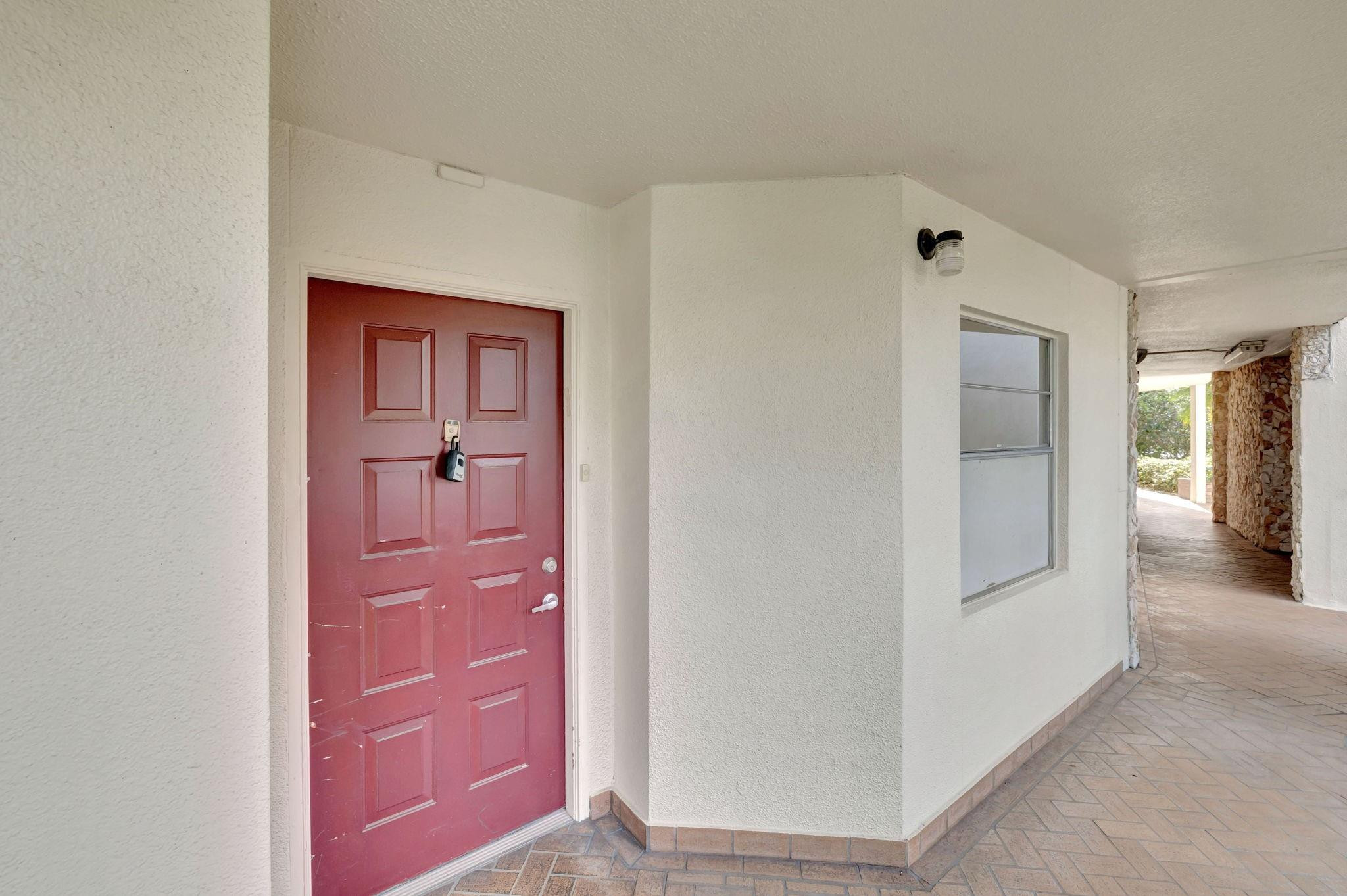 1801 Eleuthera Point, Unit E1 Coconut Creek, FL 33066 - Photo 2 of 50 a view of a hallway with closet and mirror