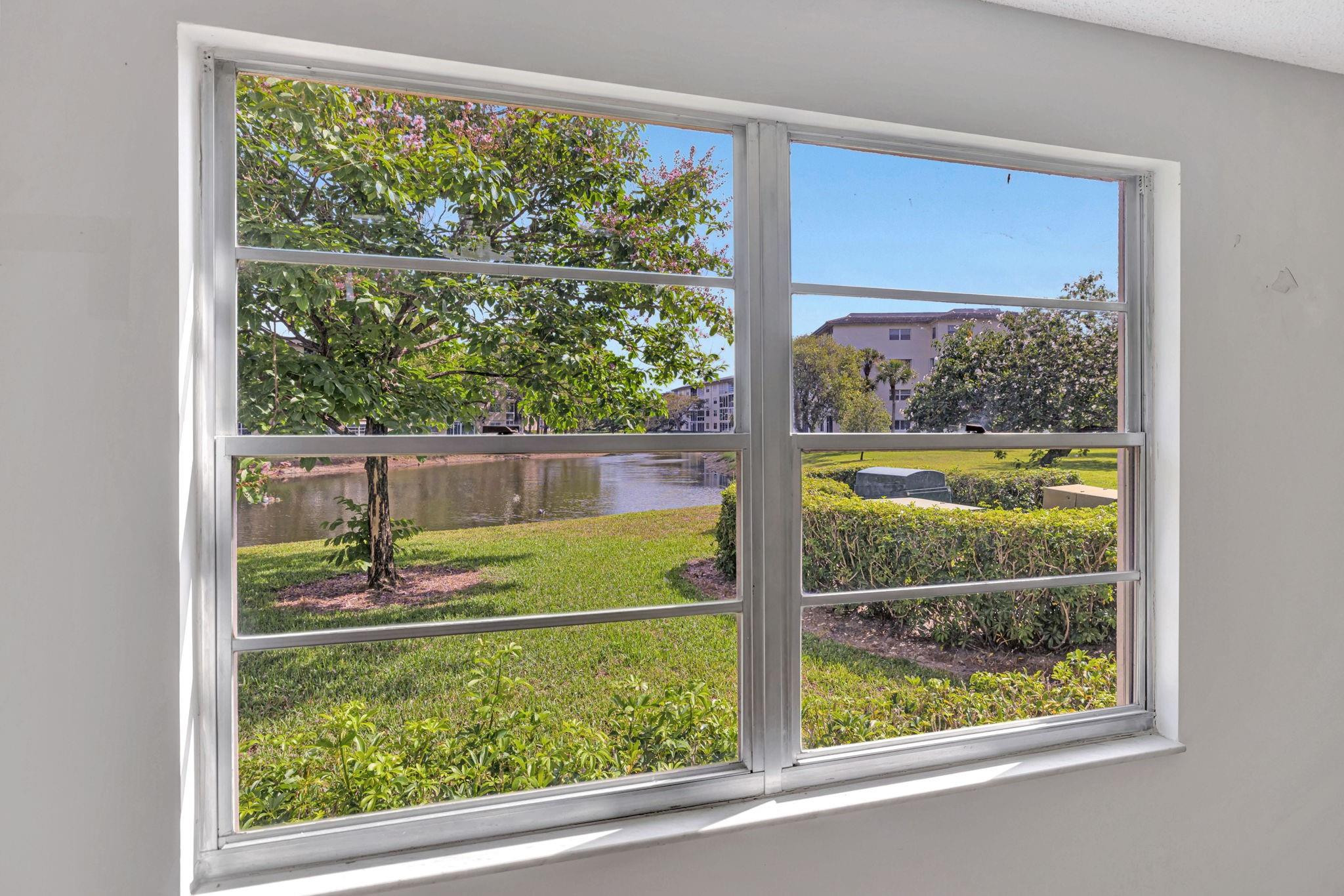 1801 Eleuthera Point, Unit E1 Coconut Creek, FL 33066 - Photo 23 of 50 a view of a room that has a bed and a window