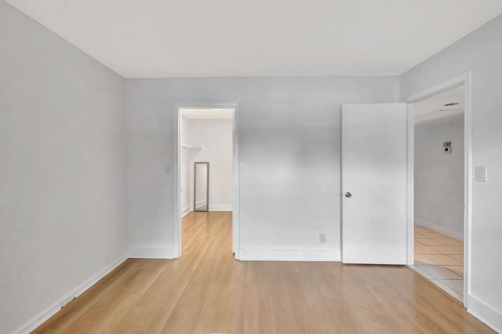 1801 Eleuthera Point, Unit E1 Coconut Creek, FL 33066 - Photo 26 of 50 a view of an empty room with wooden floor and closet