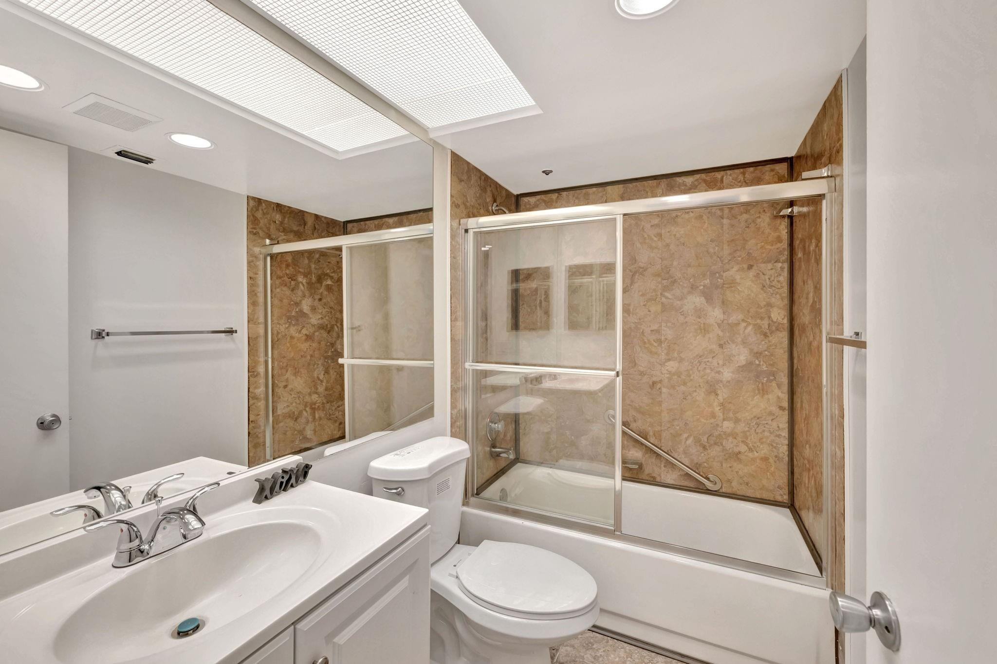 1801 Eleuthera Point, Unit E1 Coconut Creek, FL 33066 - Photo 28 of 50 a bathroom with a sink toilet and shower