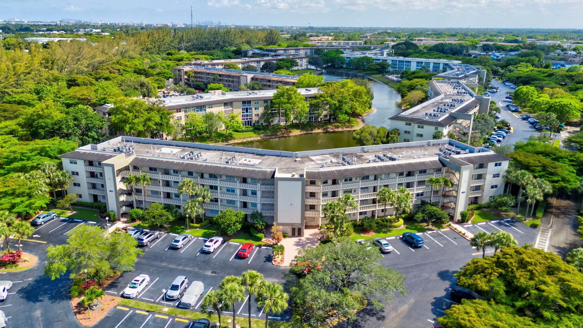 1801 Eleuthera Point, Unit E1 Coconut Creek, FL 33066 - Photo 30 of 50 a view of a swimming pool with a patio