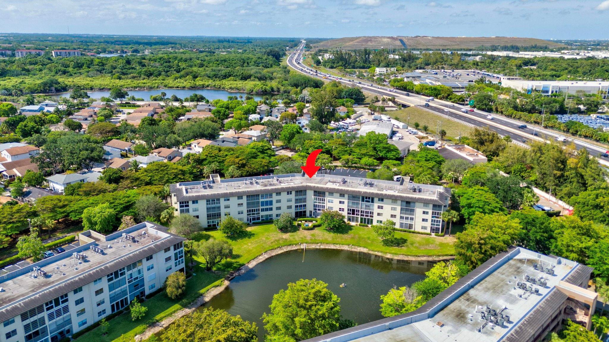 1801 Eleuthera Point, Unit E1 Coconut Creek, FL 33066 - Photo 36 of 50 a view of a swimming pool with a patio and a garden