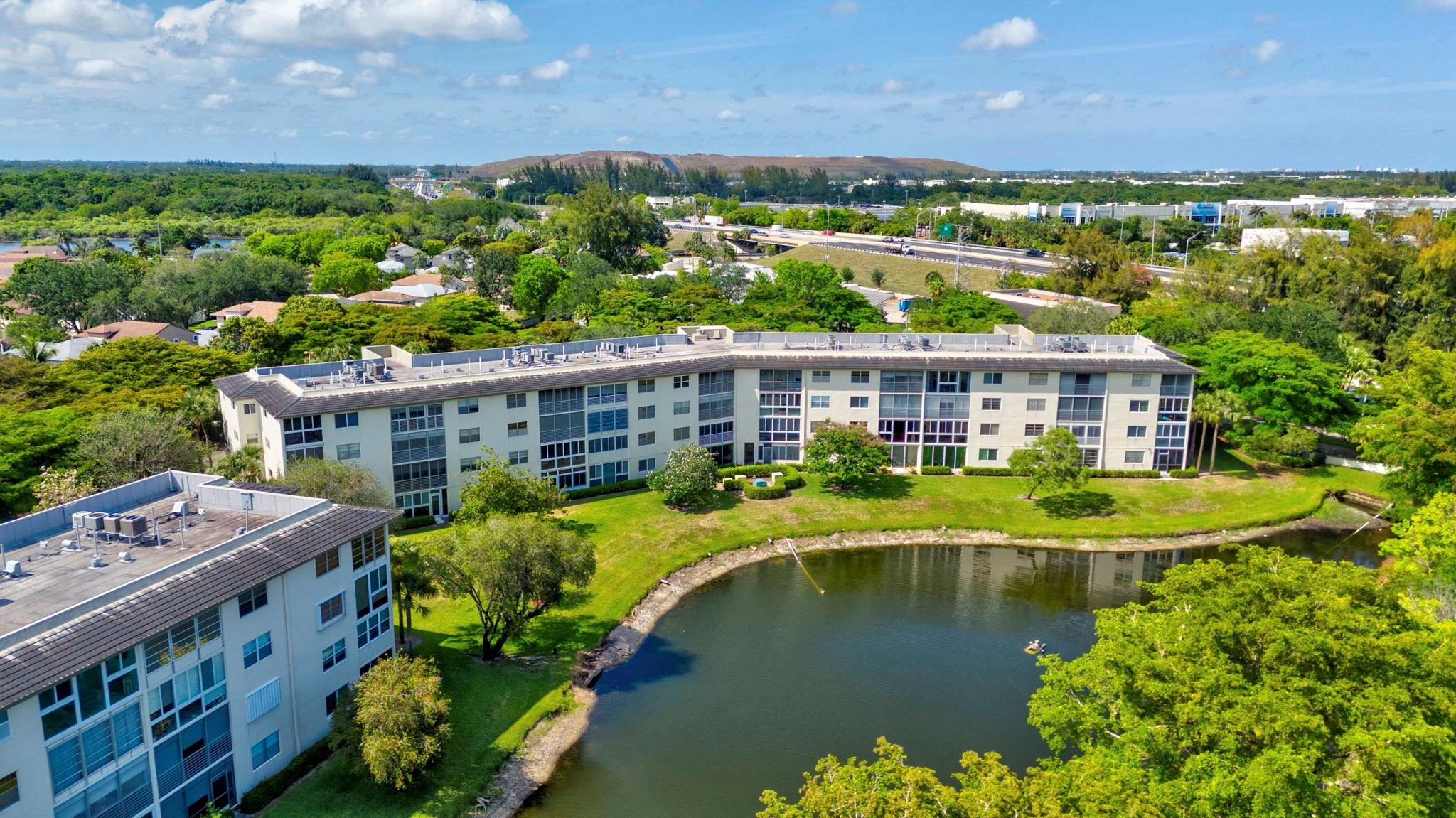 1801 Eleuthera Point, Unit E1 Coconut Creek, FL 33066 - Photo 42 of 50 an aerial view of house with yard space and swimming pool