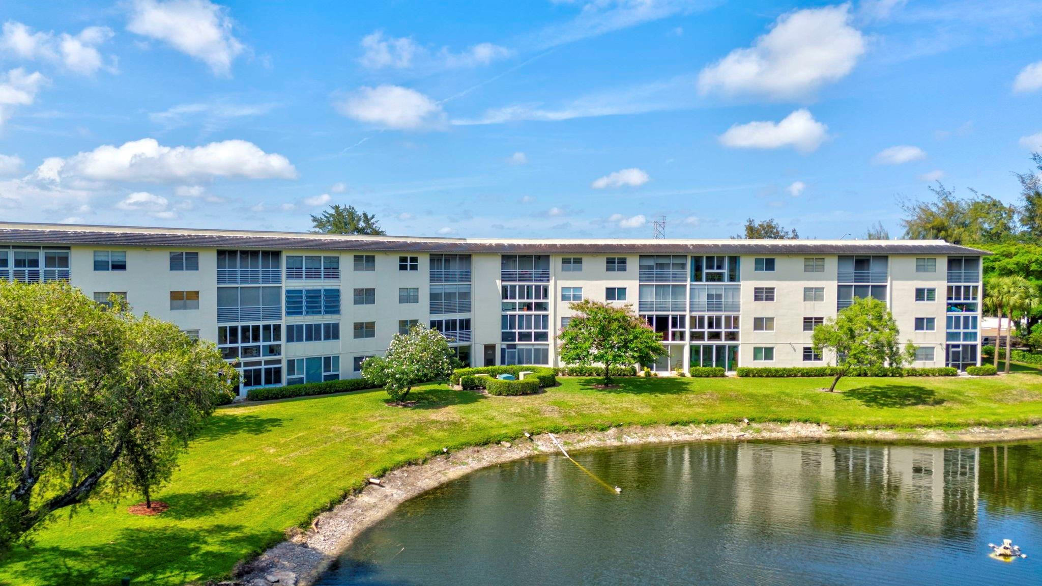 1801 Eleuthera Point, Unit E1 Coconut Creek, FL 33066 - Photo 43 of 50 a house with swimming pool in front of it