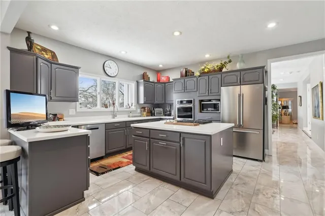 a kitchen with a sink stainless steel appliances and cabinets