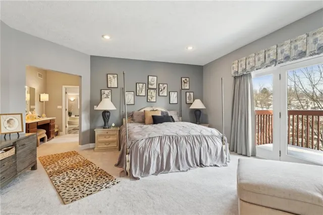 a spacious bedroom with a large bed and a couch