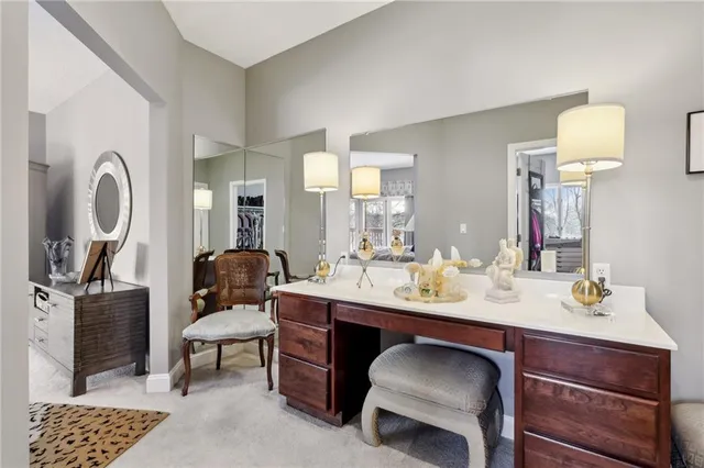 a bathroom with a sink a mirror a lamp and a window