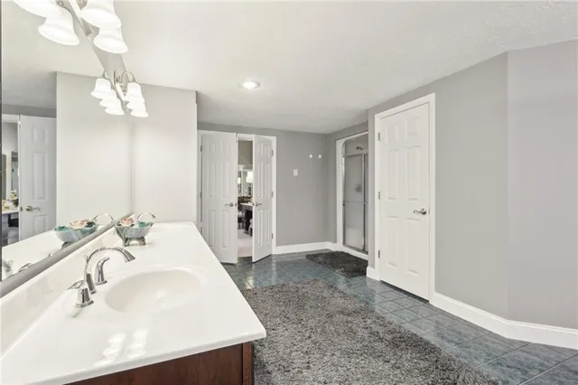 a en suite bathroom with a sink double vanity and a mirror