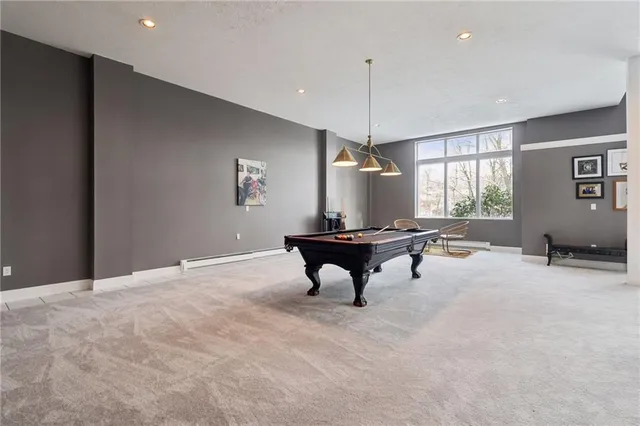 a room with pool table and windows