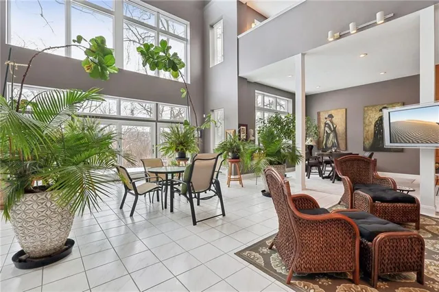 a dining room with furniture and a potted plant