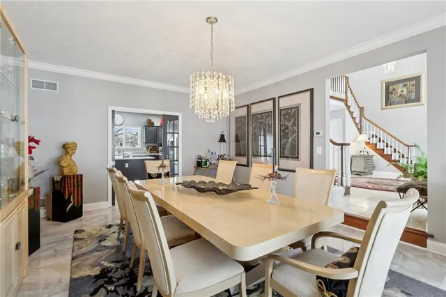 a view of a dining room with furniture and a chandelier