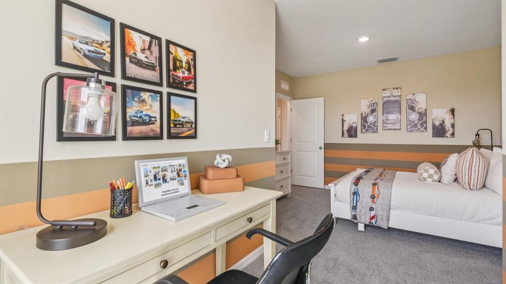 32467 Welling Blade Loop Wesley Chapel, FL 33545 - Photo 23 of 42 a bedroom with a bed and a couch