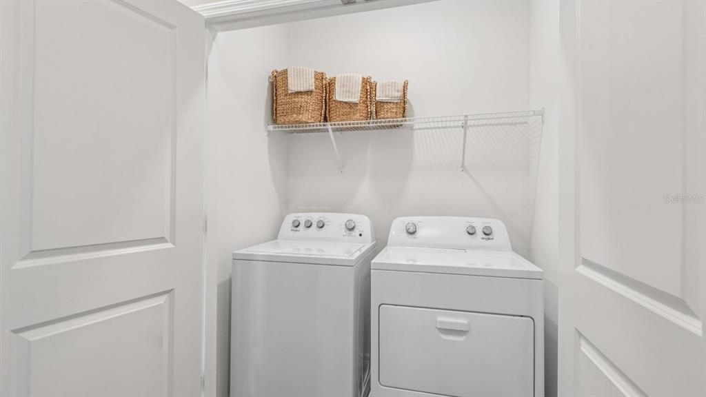 32467 Welling Blade Loop Wesley Chapel, FL 33545 - Photo 27 of 42 a view of storage and utility room with washer and dryer