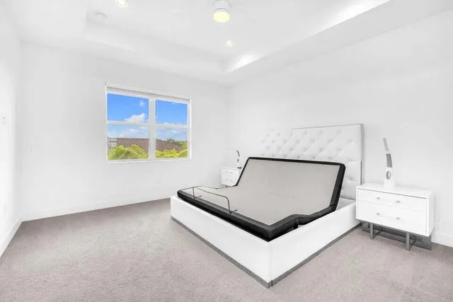 a view of a room with furniture and white wall