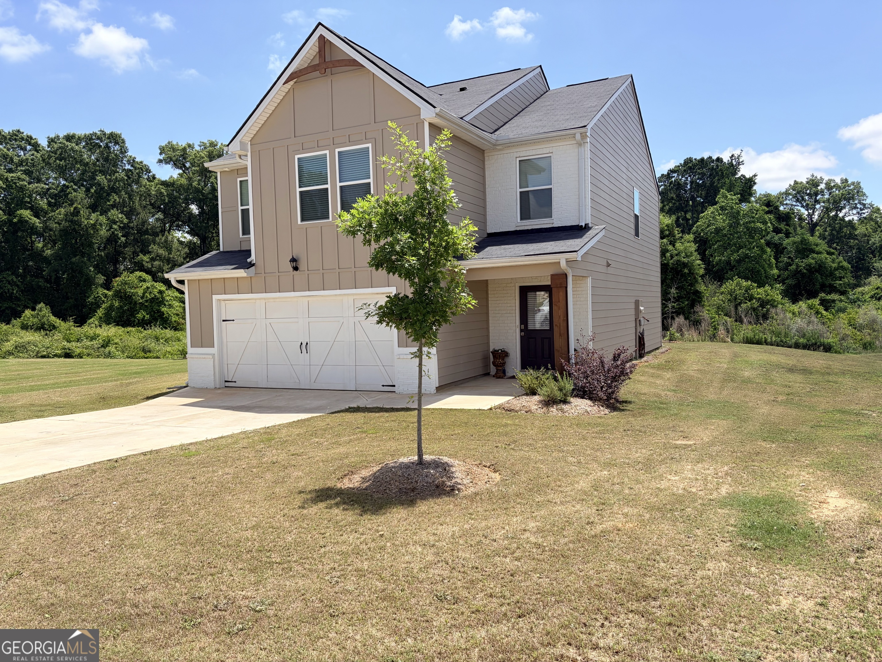 110 Red Barn Court Perry, GA 31069 - Photo 2 of 8 a front view of a house with a yard and garage