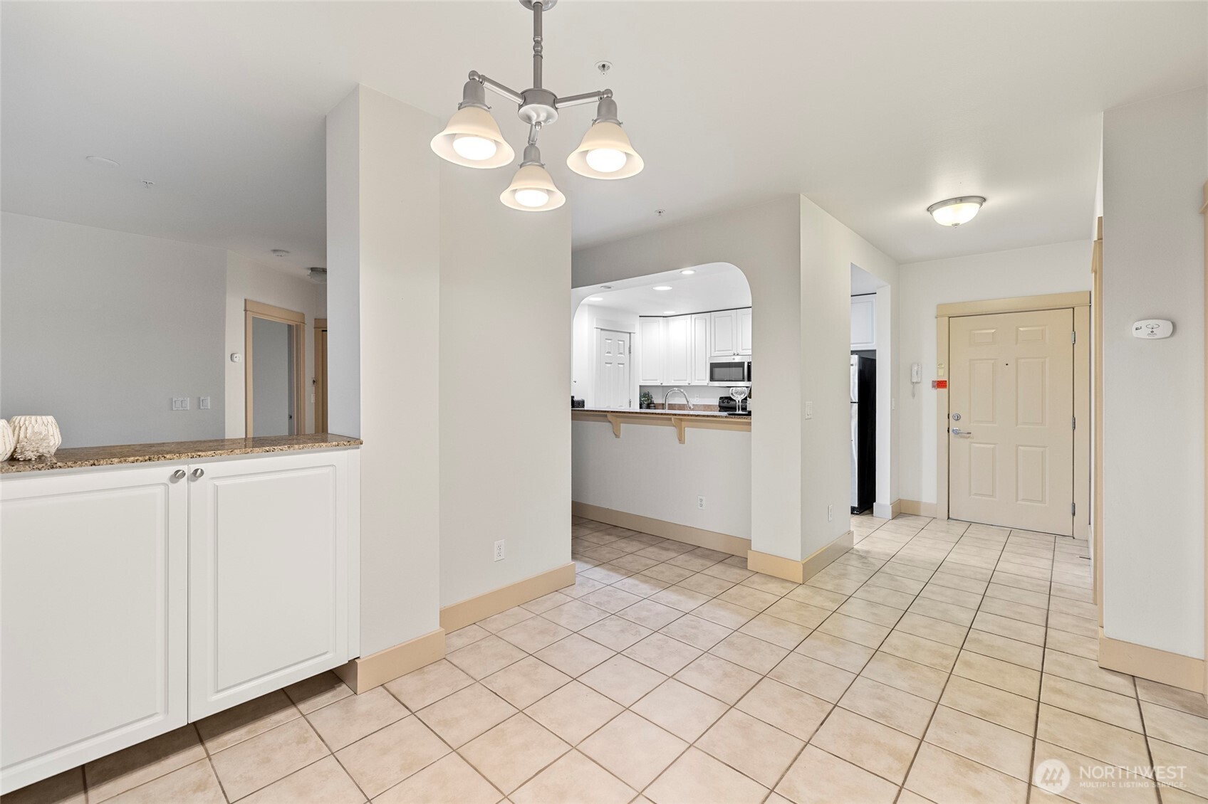 1419 Digby Place, Unit 207 Mount Vernon, WA 98274 - Photo 11 of 31 a view of a kitchen with kitchen island granite countertop stainless steel appliances cabinets and a counter top space