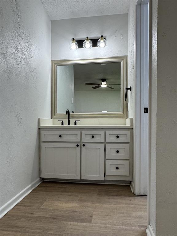 6645 Starnes Road Watauga, TX 76148 - Photo 10 of 18 Vanity with matte black fixtures, framed mirror, and built-in cabinetry with black hardware