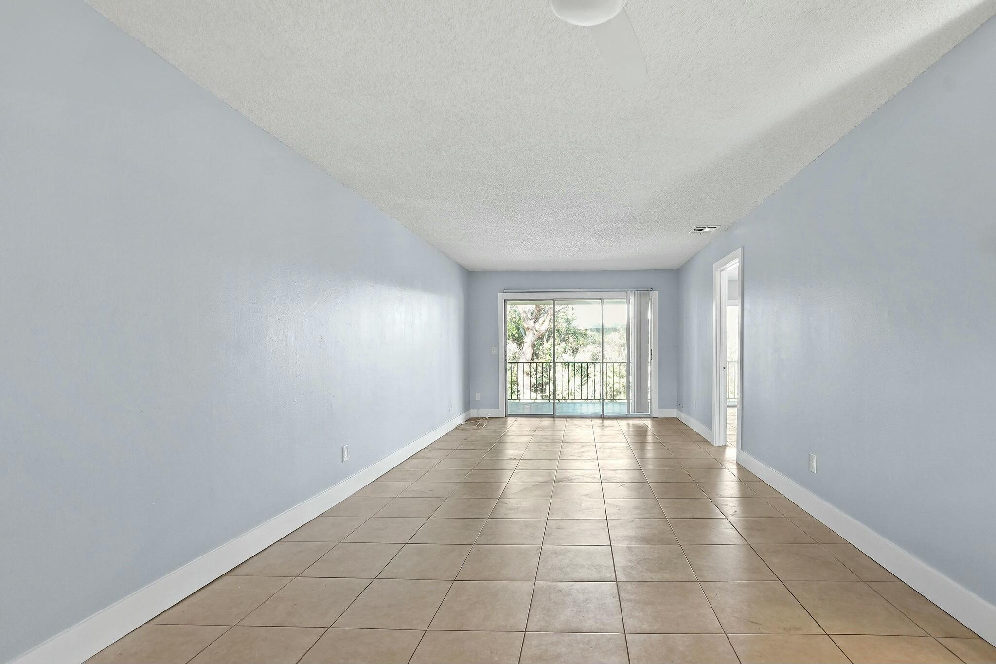 983 Northwest Spruce Ridge Drive, Unit 2 Stuart, FL 34994 - Photo 12 of 55 a view of an empty room with a window