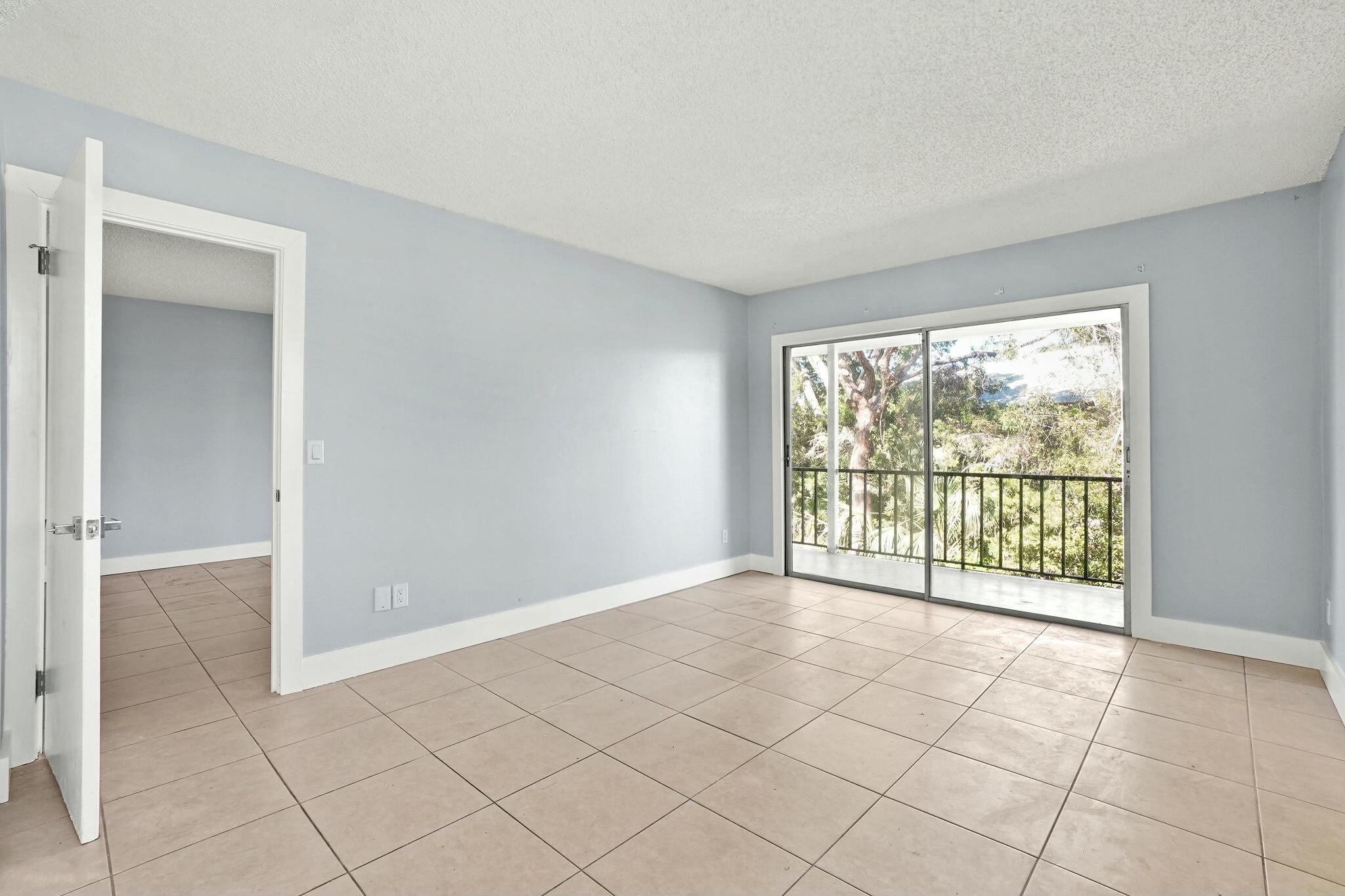 983 Northwest Spruce Ridge Drive, Unit 2 Stuart, FL 34994 - Photo 25 of 55 a view of an empty room with a window