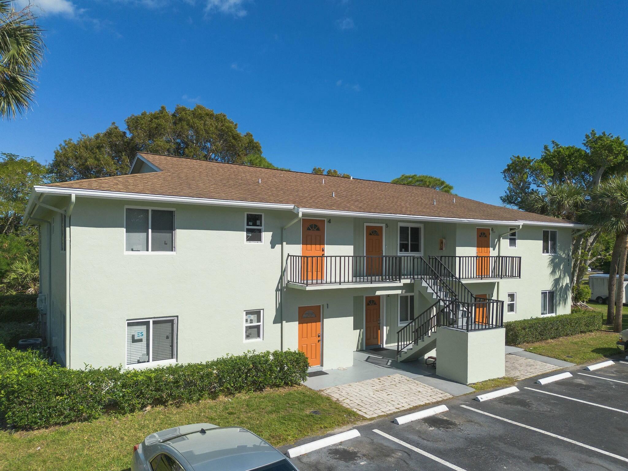983 Northwest Spruce Ridge Drive, Unit 2 Stuart, FL 34994 - Photo 3 of 55 a front view of a house with a yard