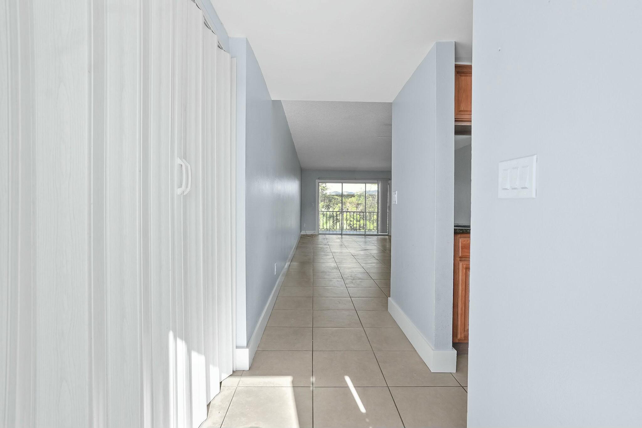 983 Northwest Spruce Ridge Drive, Unit 2 Stuart, FL 34994 - Photo 7 of 55 a view of a hallway with wooden floor