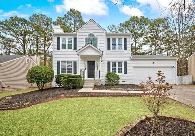 a front view of a house with garden