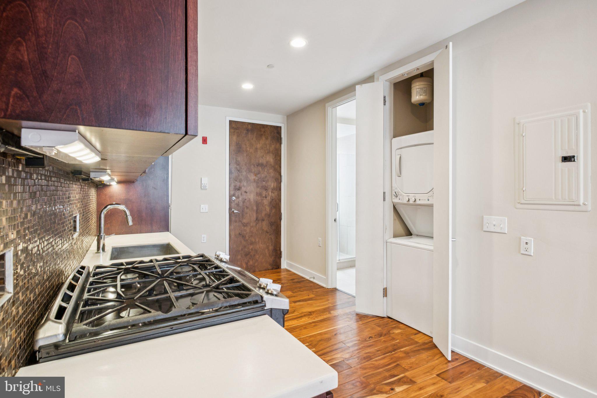 131 South 13th Street, Unit 3F Philadelphia, PA 19107 - Photo 8 of 14 a kitchen with stainless steel appliances granite countertop a stove and a refrigerator