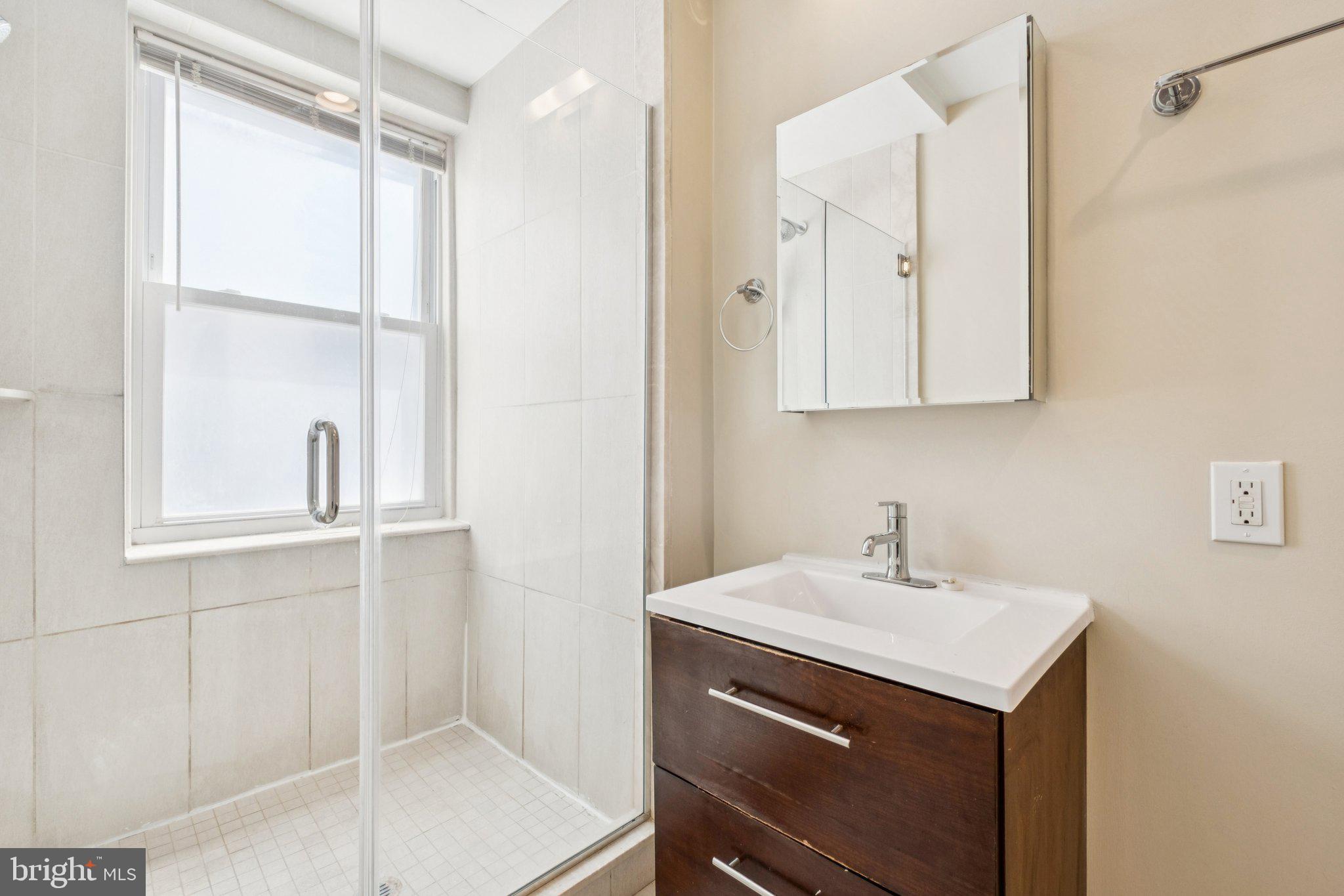 131 South 13th Street, Unit 3F Philadelphia, PA 19107 - Photo 9 of 14 a bathroom with a sink and a mirror