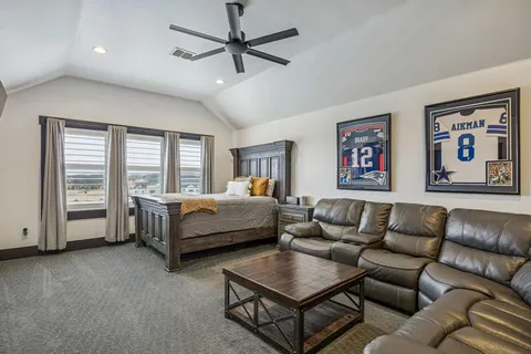 a bedroom with furniture and a ceiling fan