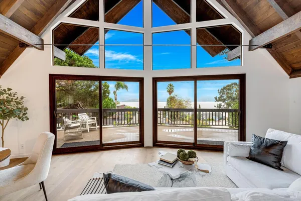a living room with furniture and a floor to ceiling window