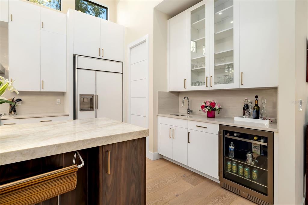 1879 Hibiscus Street Sarasota, FL 34239 - Photo 17 of 84 a kitchen with stainless steel appliances cabinets and wooden floor
