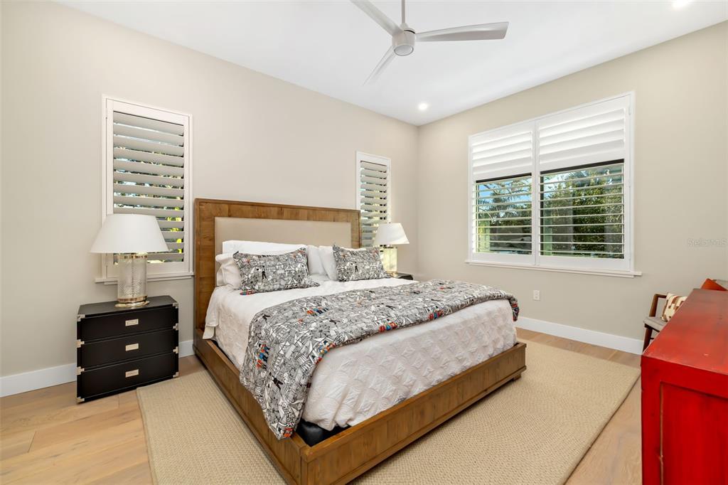 1879 Hibiscus Street Sarasota, FL 34239 - Photo 44 of 84 a bedroom with a bed window and a chandelier