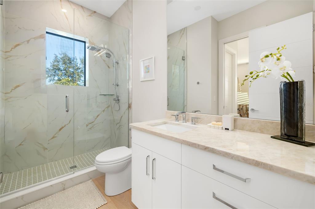 1879 Hibiscus Street Sarasota, FL 34239 - Photo 54 of 84 a bathroom with a granite countertop sink toilet and shower