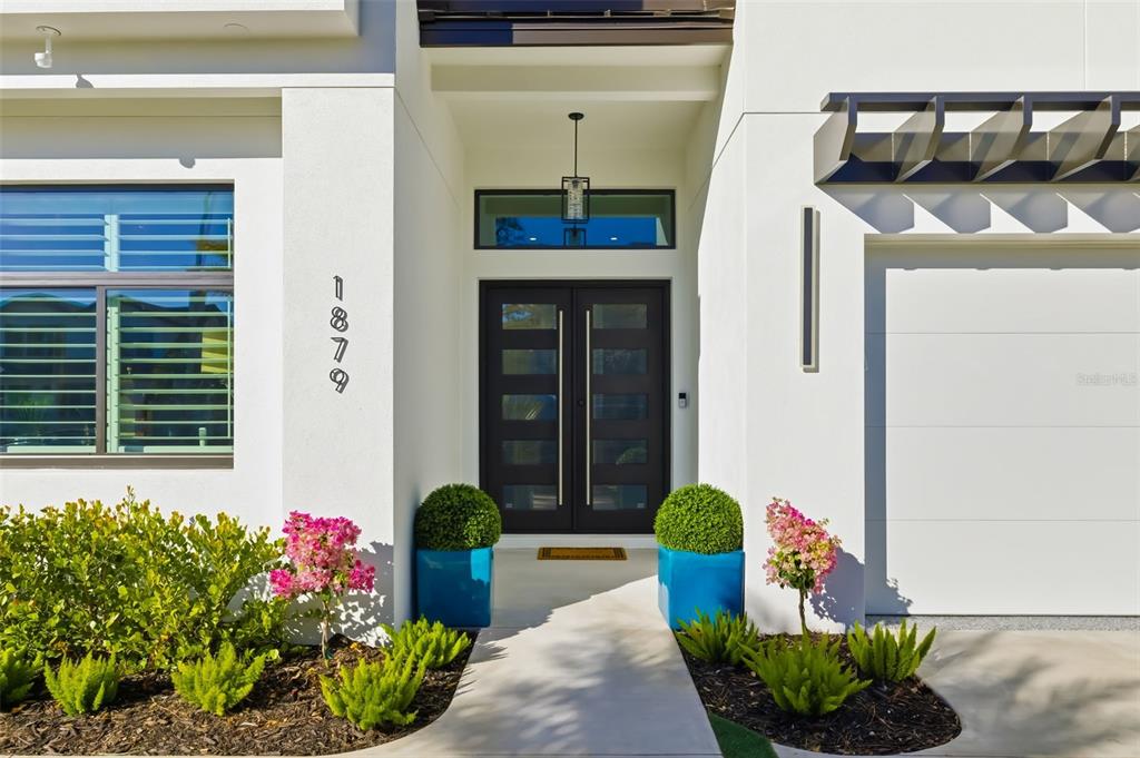 1879 Hibiscus Street Sarasota, FL 34239 - Photo 80 of 84 a front view of a house with outdoor seating and plants