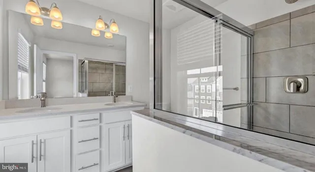 a bathroom with a double vanity sink and a mirror