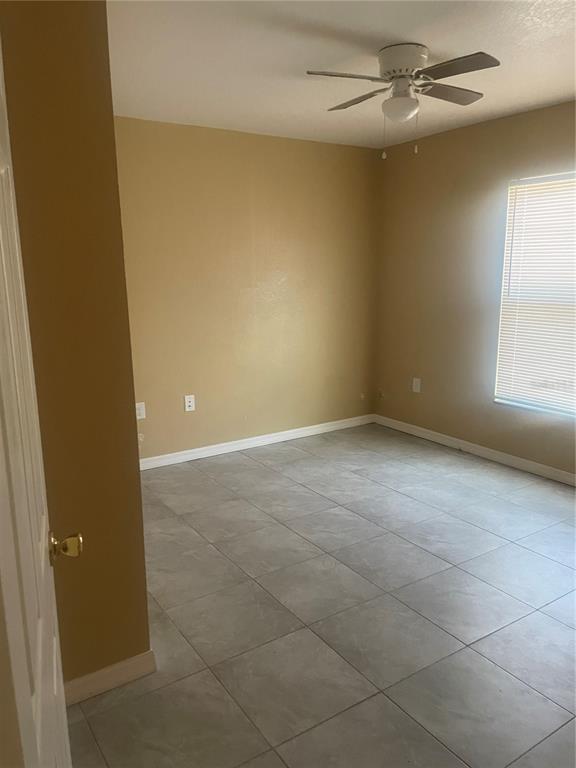 512 Valencia Street Sebring, FL 33870 - Photo 13 of 13 an empty room with windows and fan