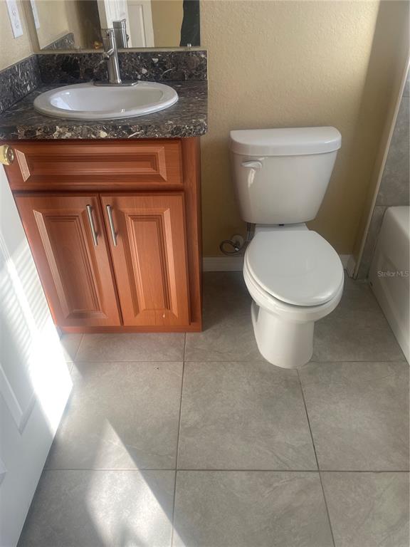512 Valencia Street Sebring, FL 33870 - Photo 10 of 13 a bathroom with a toilet a sink and a mirror