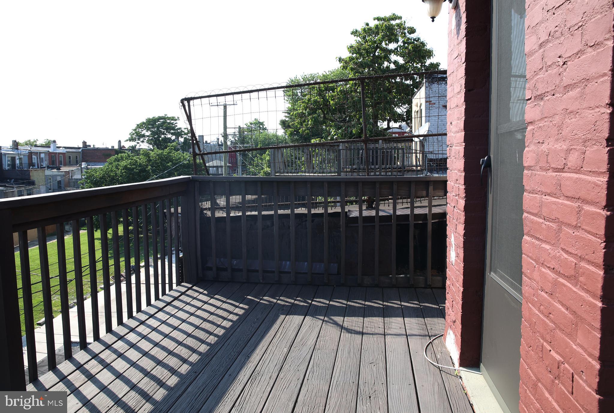 2226 Eutaw Place, Unit 3 Baltimore, MD 21217 - Photo 14 of 15 a view of a balcony with wooden floor