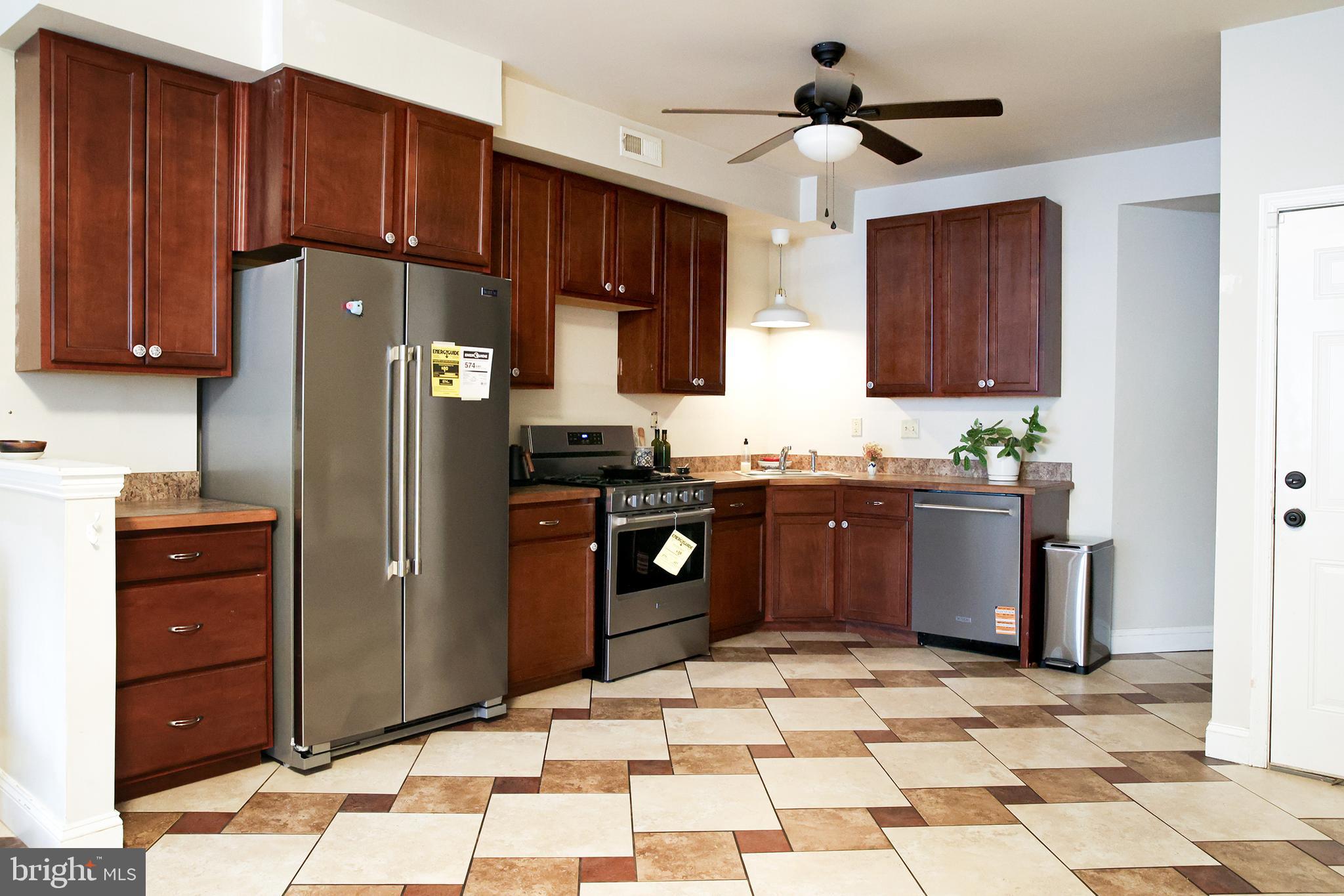 2226 Eutaw Place, Unit 3 Baltimore, MD 21217 - Photo 6 of 15 a kitchen with stainless steel appliances granite countertop a refrigerator and a sink
