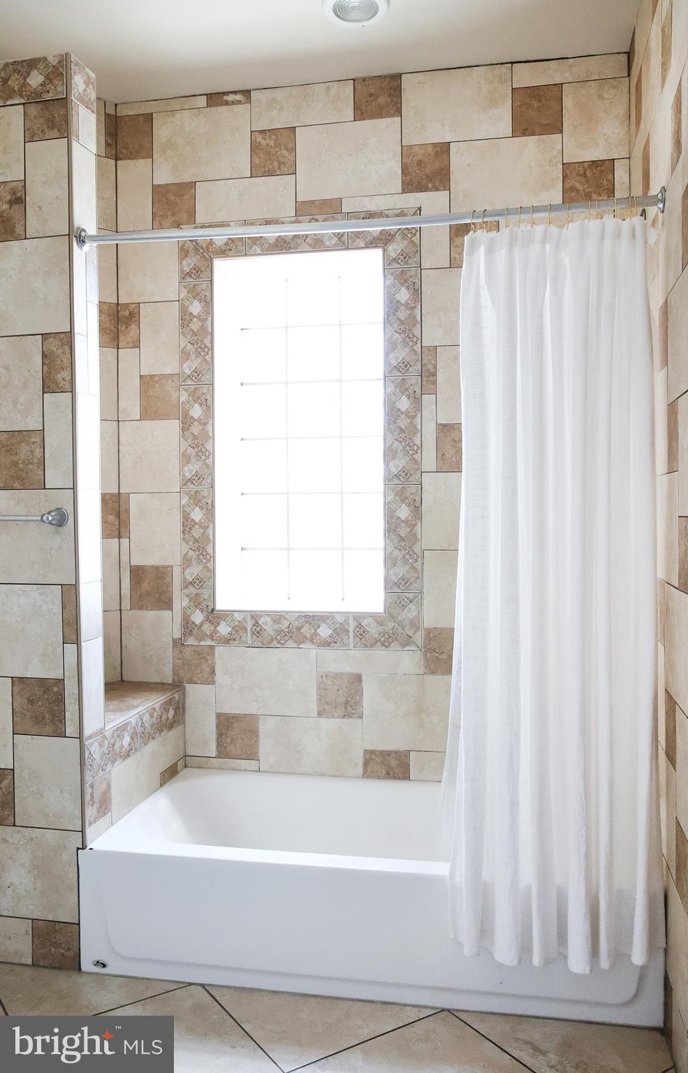 2226 Eutaw Place, Unit 3 Baltimore, MD 21217 - Photo 10 of 15 a white bath tub sitting next to a white sink