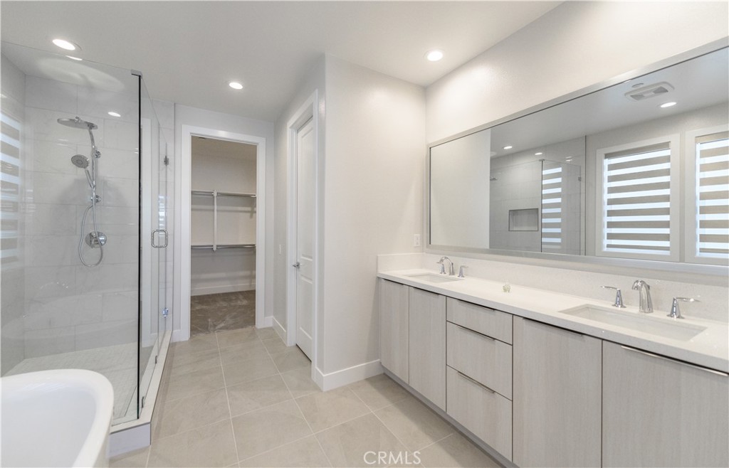240 Longden Lake Forest, CA 92630 - Photo 18 of 32 a bathroom with a double vanity sink mirror and shower