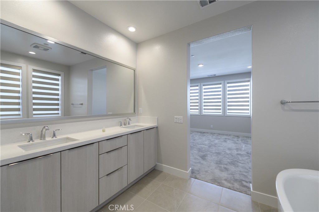 240 Longden Lake Forest, CA 92630 - Photo 21 of 32 a bathroom with a double vanity sink and a mirror
