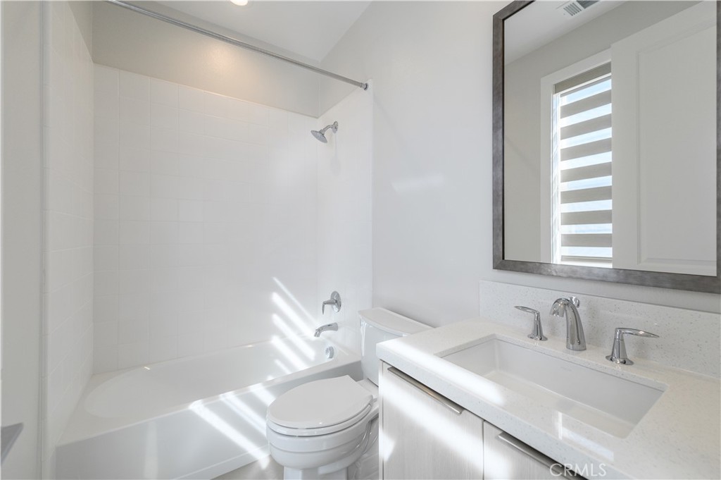 240 Longden Lake Forest, CA 92630 - Photo 27 of 32 a bathroom with a granite countertop sink a toilet and a mirror
