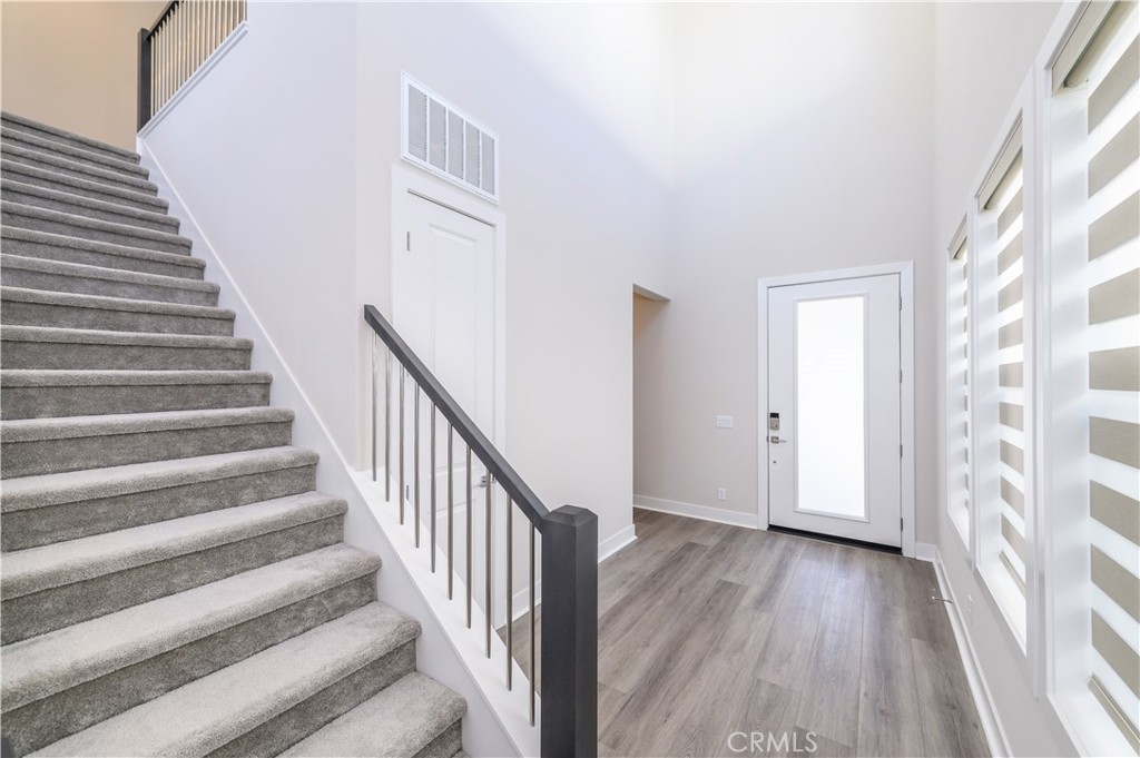 240 Longden Lake Forest, CA 92630 - Photo 3 of 32 a view of a hallway with wooden floor and entryway