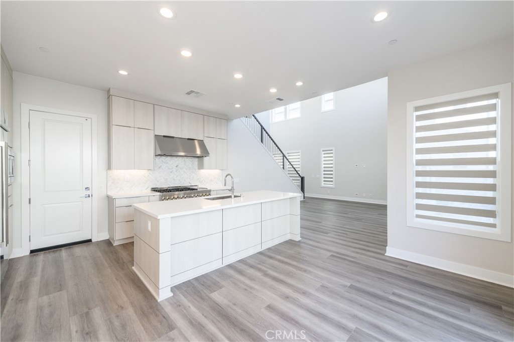 240 Longden Lake Forest, CA 92630 - Photo 7 of 32 a kitchen with a sink stove and wooden floor