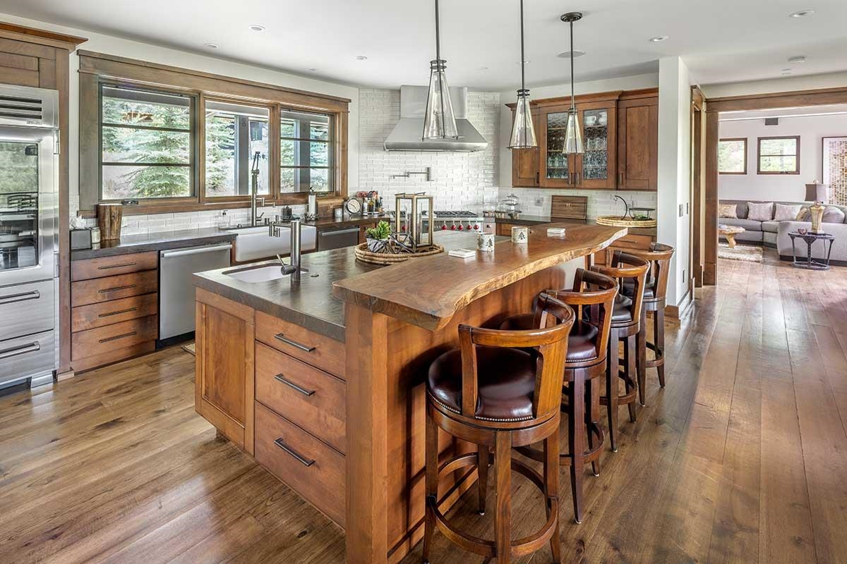 9619 Dunsmuir Way Truckee, CA 96161 - Photo 12 of 24 a kitchen with stainless steel appliances kitchen island granite countertop a table chairs and a large window
